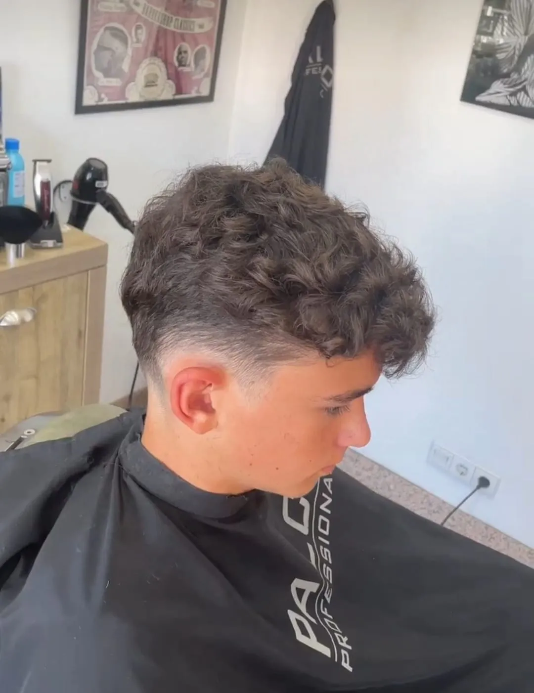 Curls on top, low fade at the sides